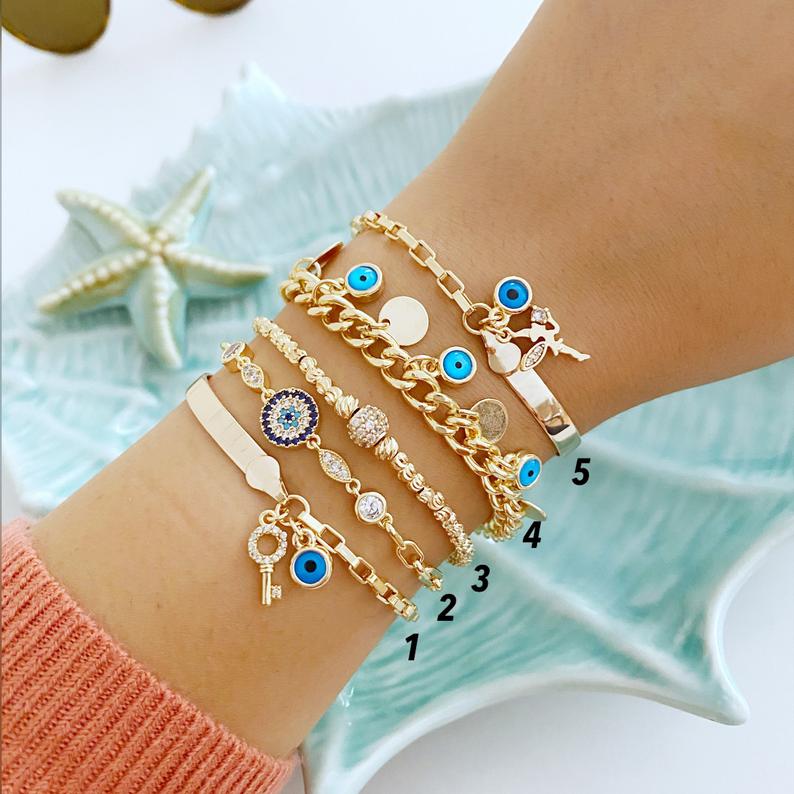 Gold Evil Eye Chain Bracelet featuring a blue charm, handmade with adjustable stainless steel for durability and style.