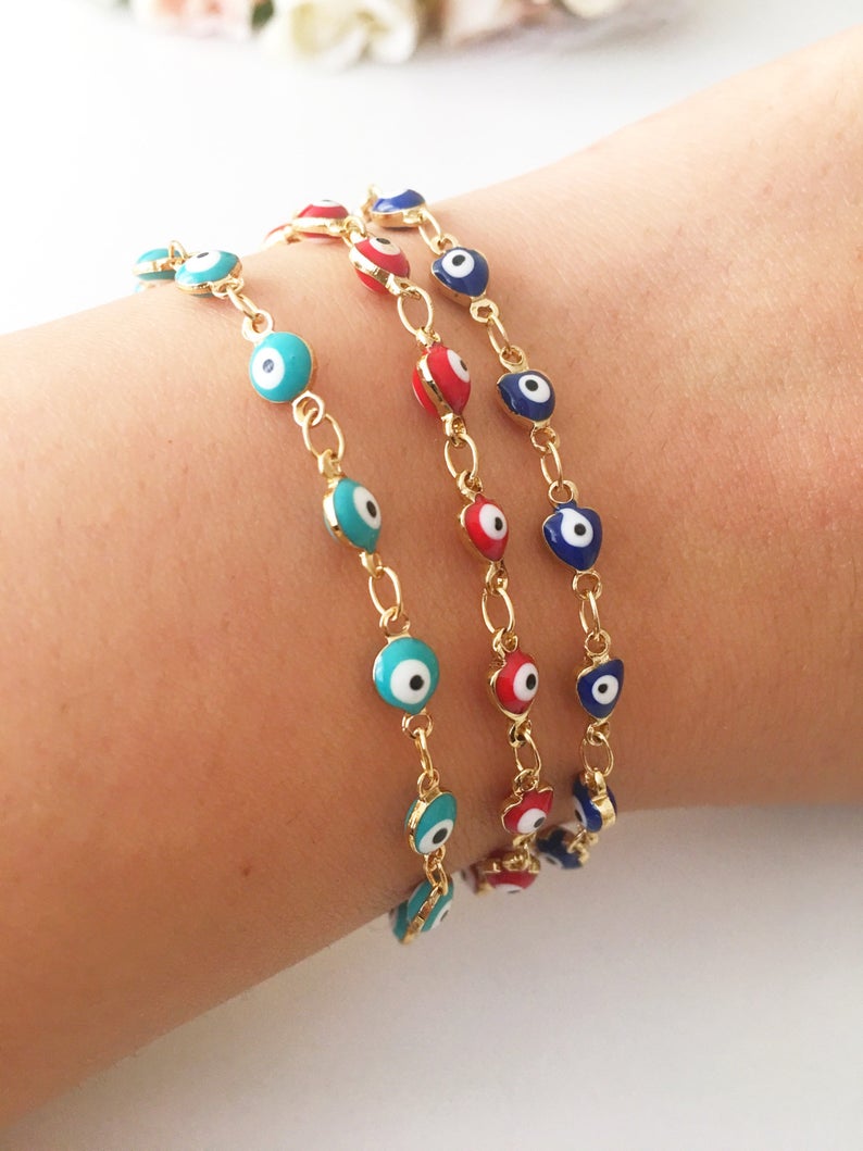 A beautiful Evil Eye Chain Bracelet featuring a gold link chain and tiny blue evil eye beads, perfect for minimalist jewelry lovers.