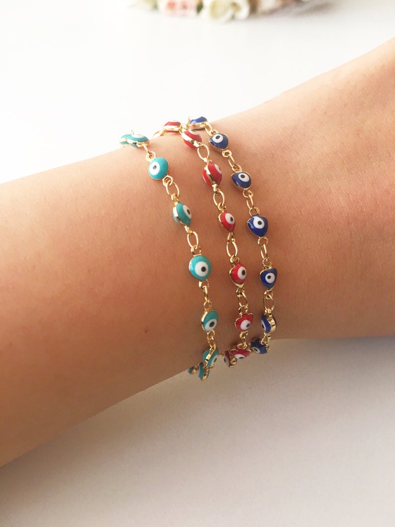 A beautiful Evil Eye Chain Bracelet featuring a gold link chain and tiny blue evil eye beads, perfect for minimalist jewelry lovers.