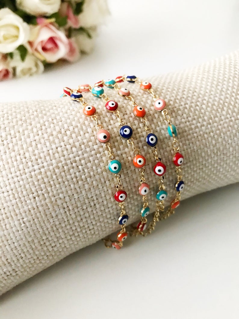 Evil Eye Chain Bracelet featuring colorful evil eye beads on a gold chain, showcasing vibrant colors and a stylish design.