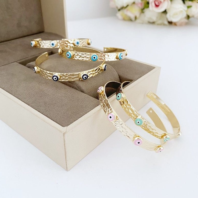 Gold Evil Eye Cuff Bracelet featuring a movable evil eye charm, perfect for boho style.