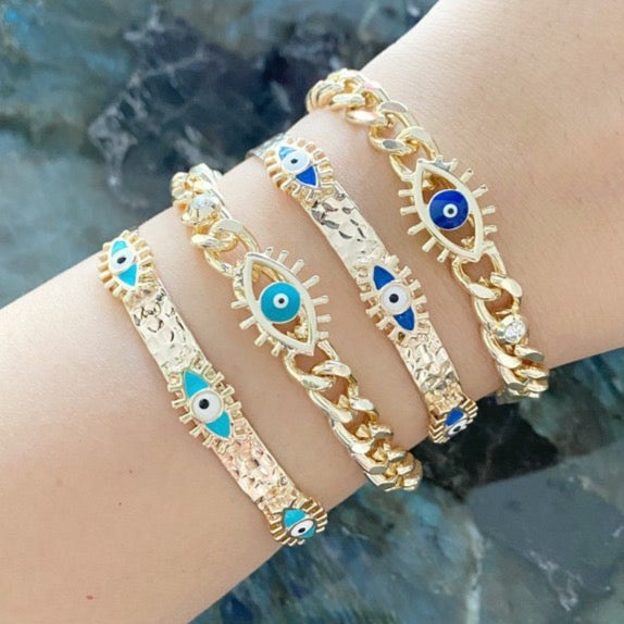 Gold Evil Eye Cuff Bracelet featuring a movable blue evil eye charm, adjustable design, and tarnish resistant stainless steel material.