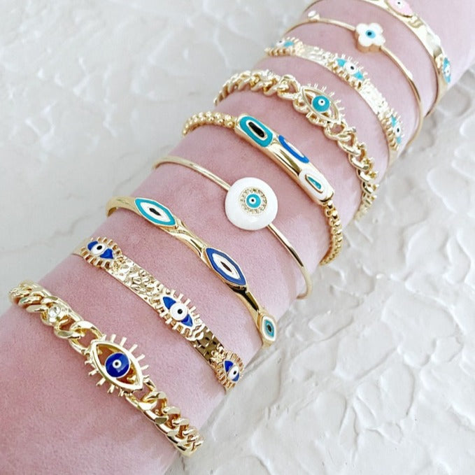 Gold Evil Eye Cuff Bracelet Set featuring a blue evil eye talisman, handmade with tarnish-free 316L stainless steel, adjustable for all wrist sizes.