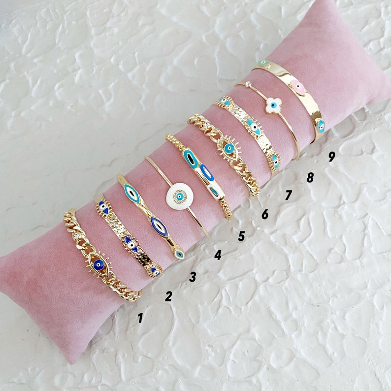 Gold Evil Eye Cuff Bracelet Set featuring a blue evil eye talisman, handmade with tarnish-free 316L stainless steel, adjustable for all wrist sizes.