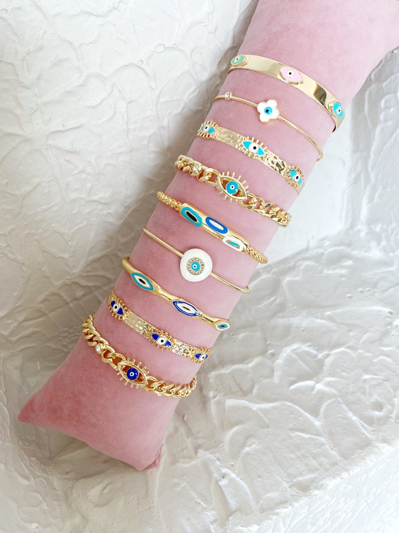 Gold Evil Eye Cuff Bracelet Set featuring a blue evil eye talisman, handmade with tarnish-free 316L stainless steel, adjustable for all wrist sizes.
