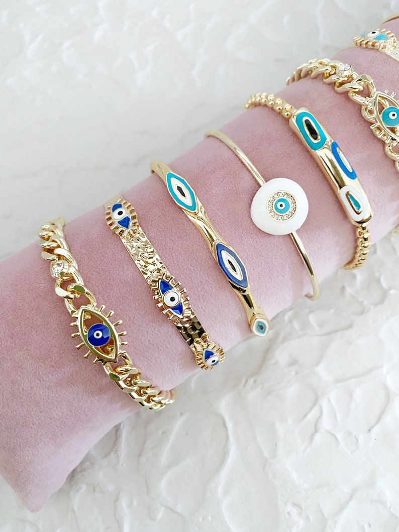 Gold Evil Eye Cuff Bracelet Set featuring a blue evil eye talisman, handmade with tarnish-free 316L stainless steel, adjustable for all wrist sizes.