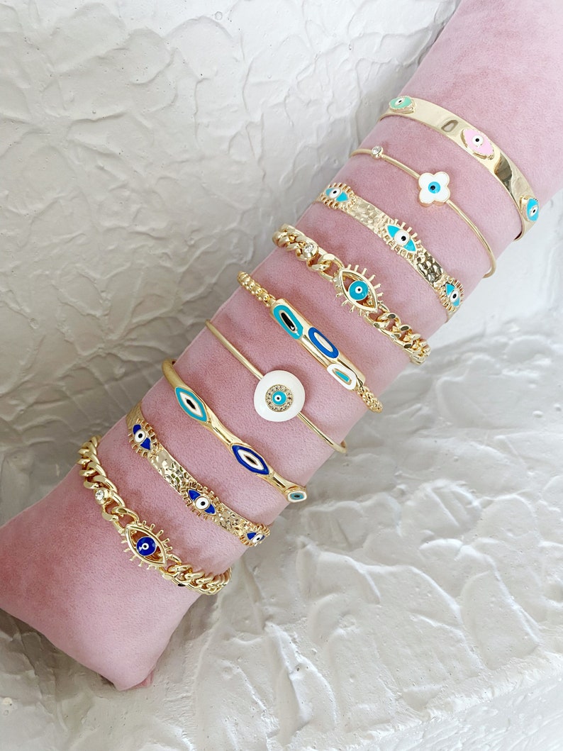 Gold Evil Eye Cuff Bracelet Set featuring a blue evil eye talisman, handmade with tarnish-free 316L stainless steel, adjustable for all wrist sizes.