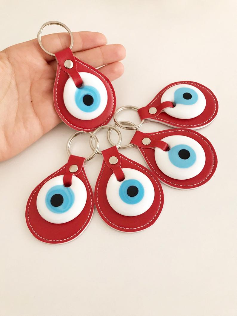 Evil eye elegant leather keychain in various colors, featuring a glass evil eye charm.