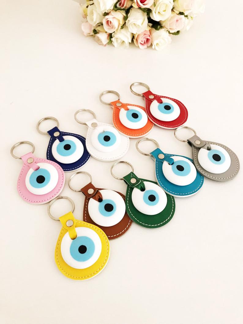 Evil eye elegant leather keychain in various colors, featuring a glass evil eye charm.