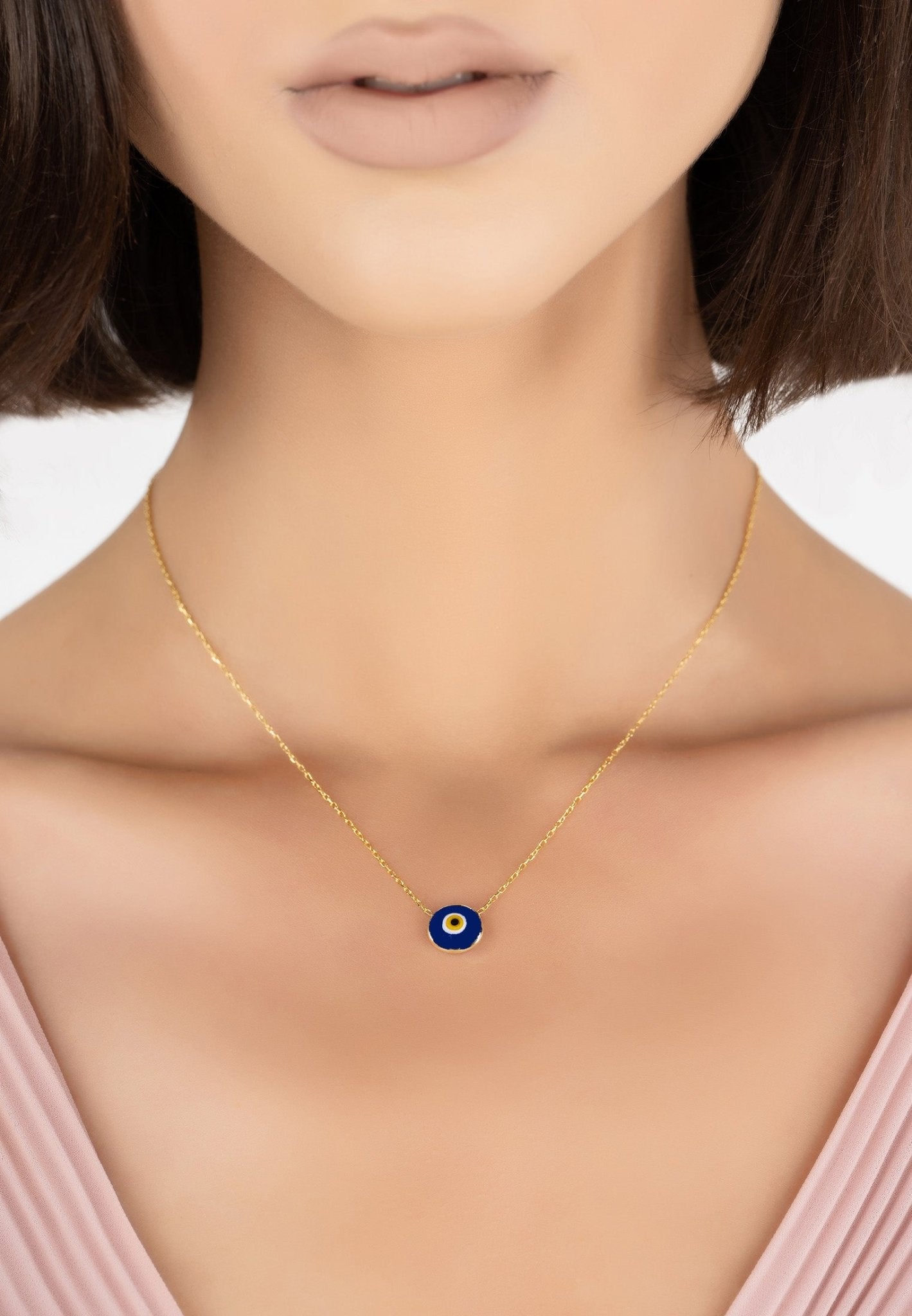 Gold evil eye enamel pendant necklace featuring colorful rings and a bevelled disc design, perfect for everyday wear.