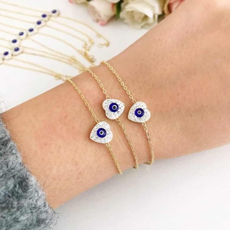 Evil Eye Heart Bracelet featuring a gold chain and heart charm, symbolizing protection and good luck.
