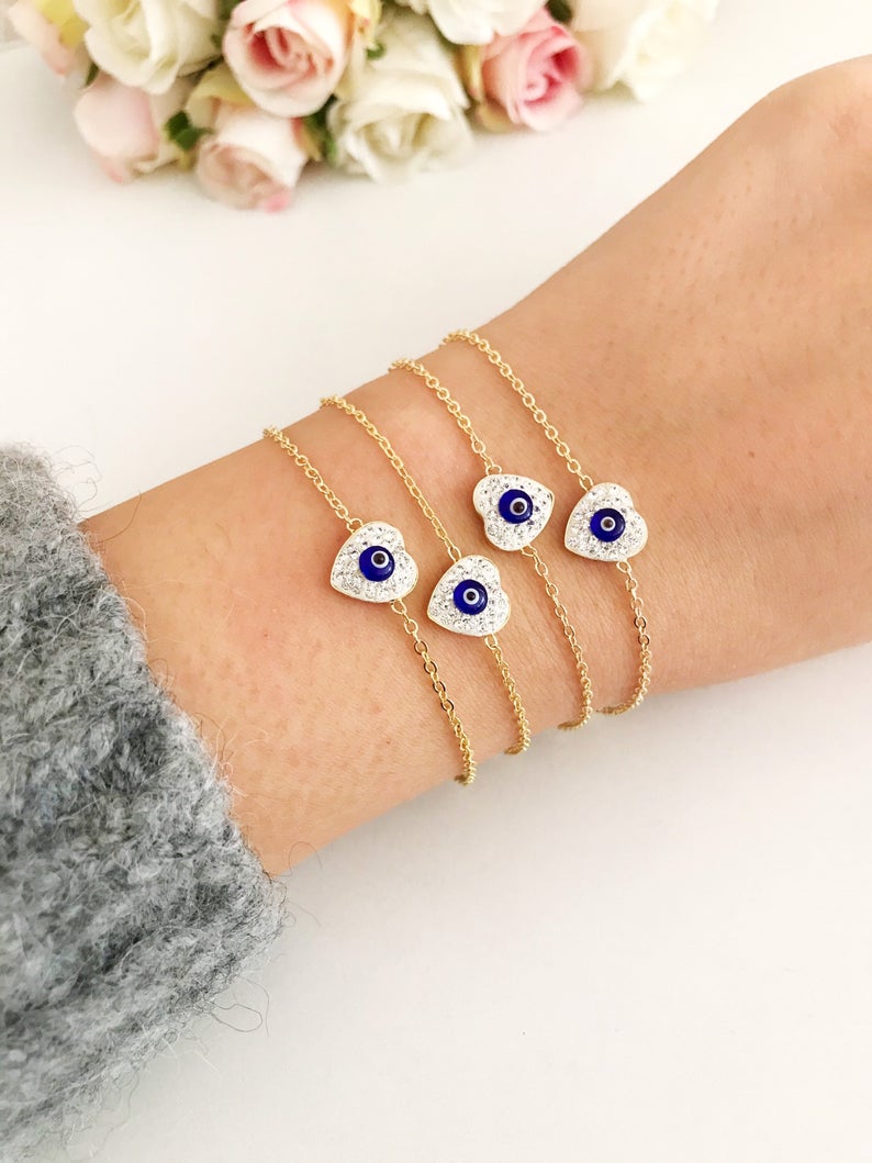 Evil Eye Heart Bracelet featuring a gold chain and heart charm, symbolizing protection and good luck.