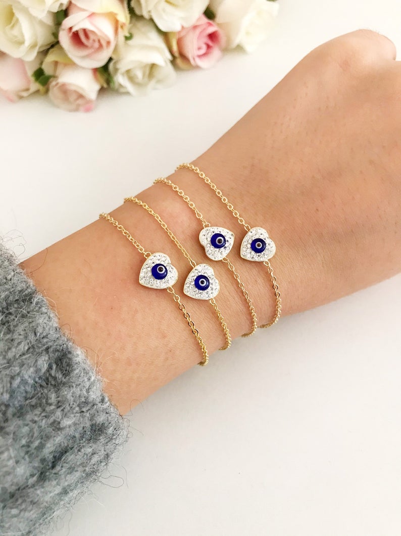 Evil Eye Heart Bracelet featuring a gold chain and heart charm, symbolizing protection and good luck.