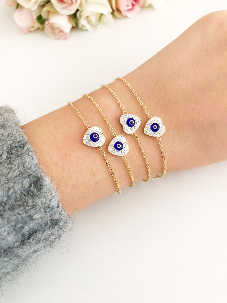 Evil Eye Heart Bracelet featuring a gold chain and heart charm, symbolizing protection and good luck.