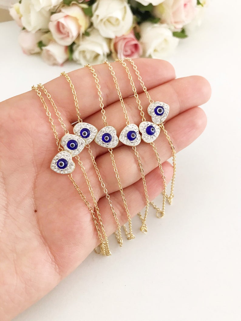 Evil Eye Heart Bracelet featuring a gold chain and heart charm, symbolizing protection and good luck.