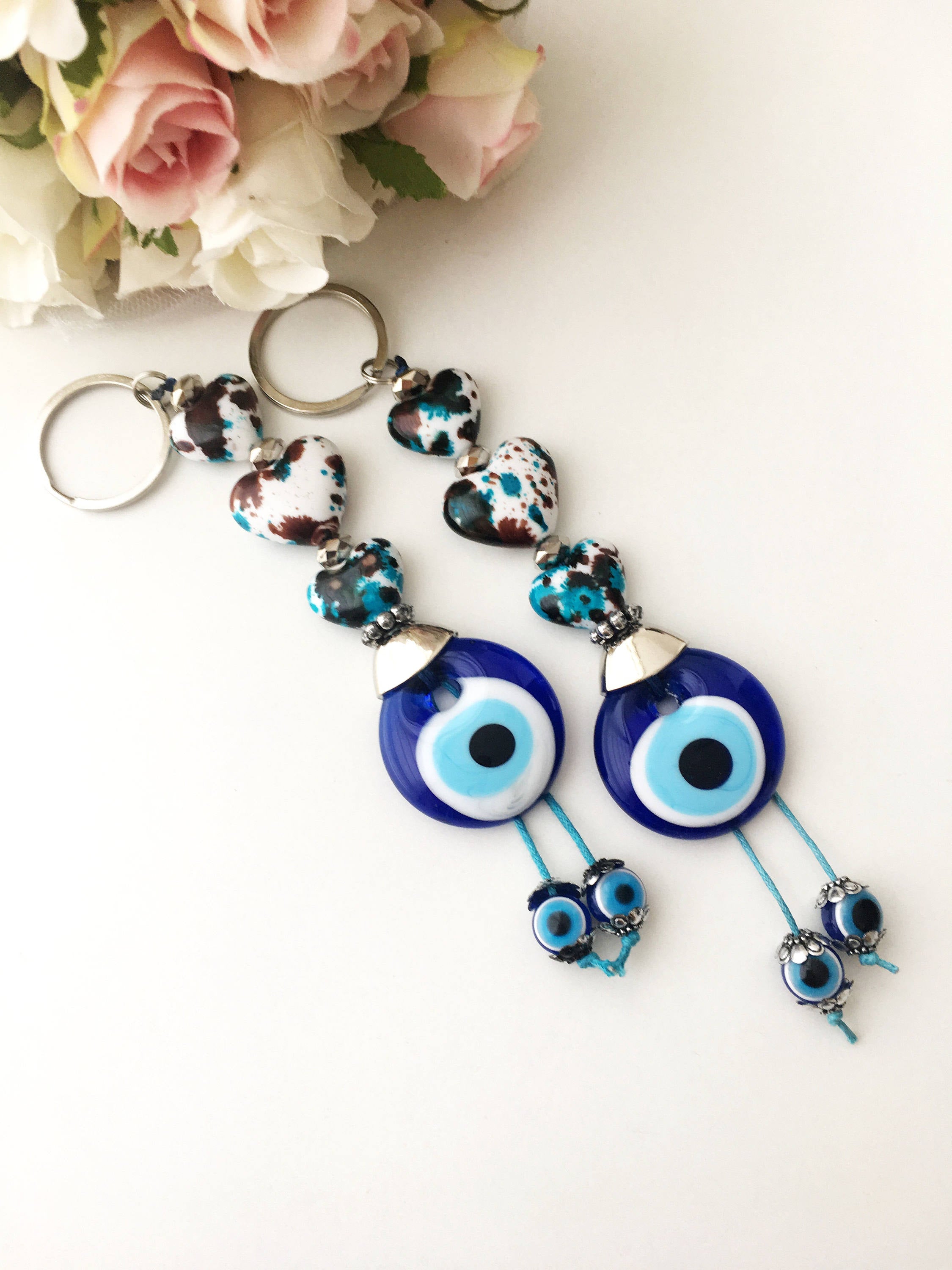 Evil eye key chain featuring a ceramic heart charm, symbolizing protection and good luck, perfect for keys or bags.