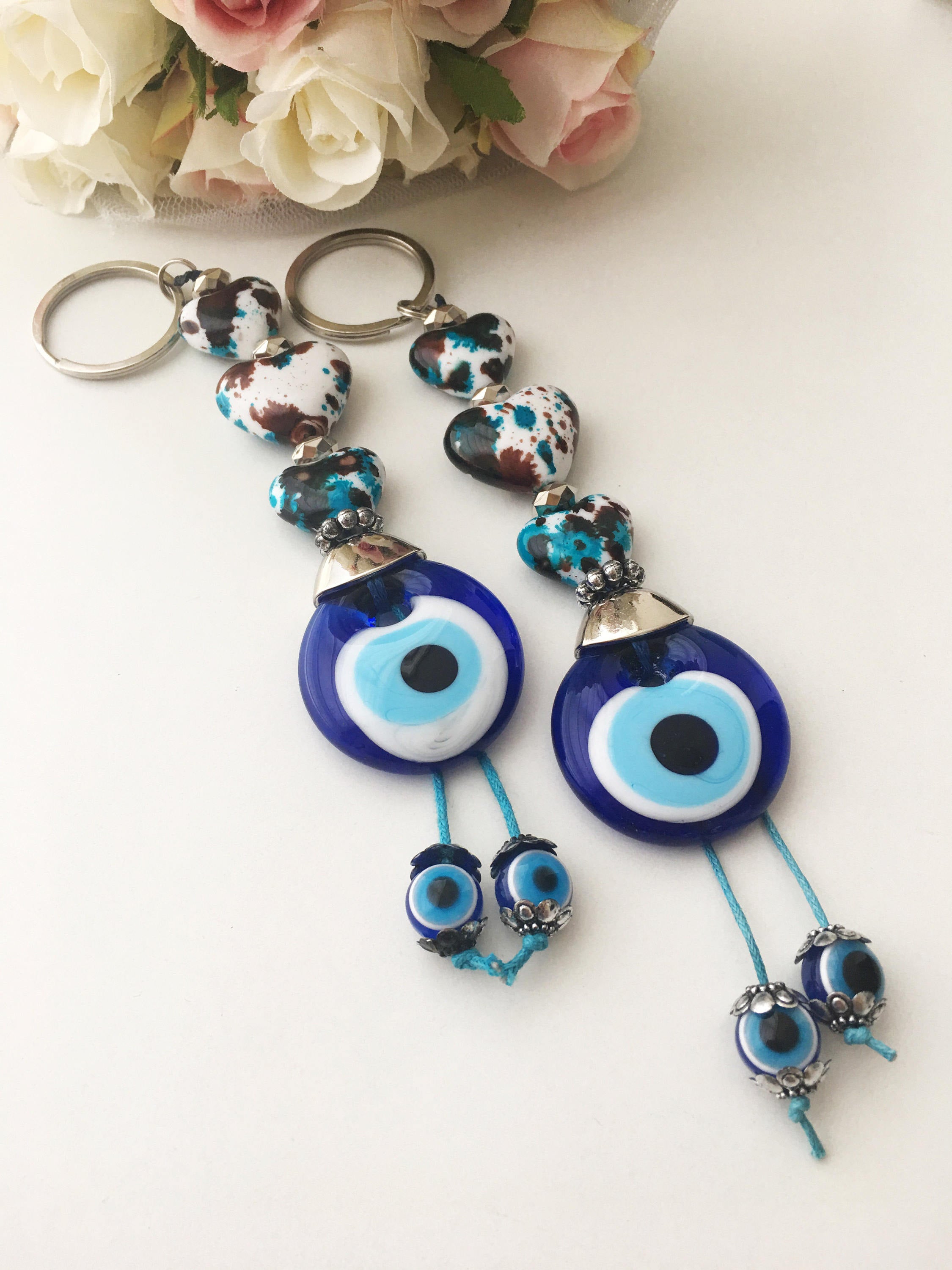 Evil eye key chain featuring a ceramic heart charm, symbolizing protection and good luck, perfect for keys or bags.