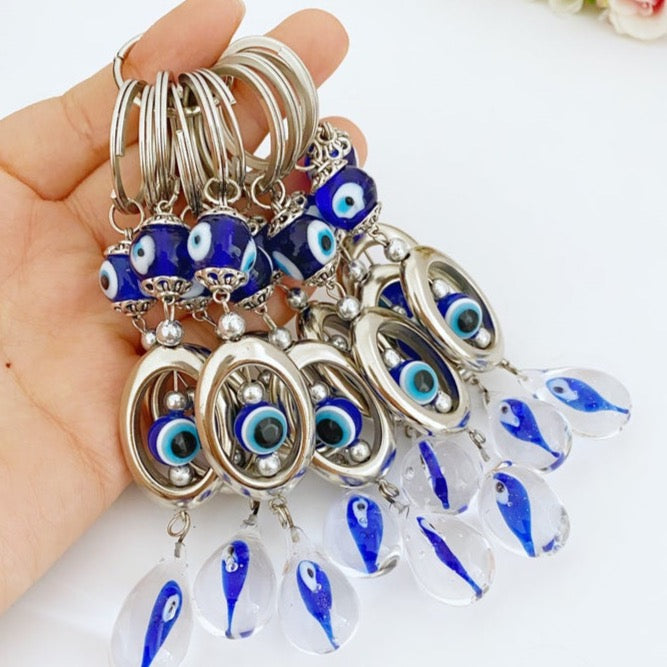 A beautifully crafted glass evil eye keychain featuring vibrant blue and white colors, symbolizing protection and good luck.