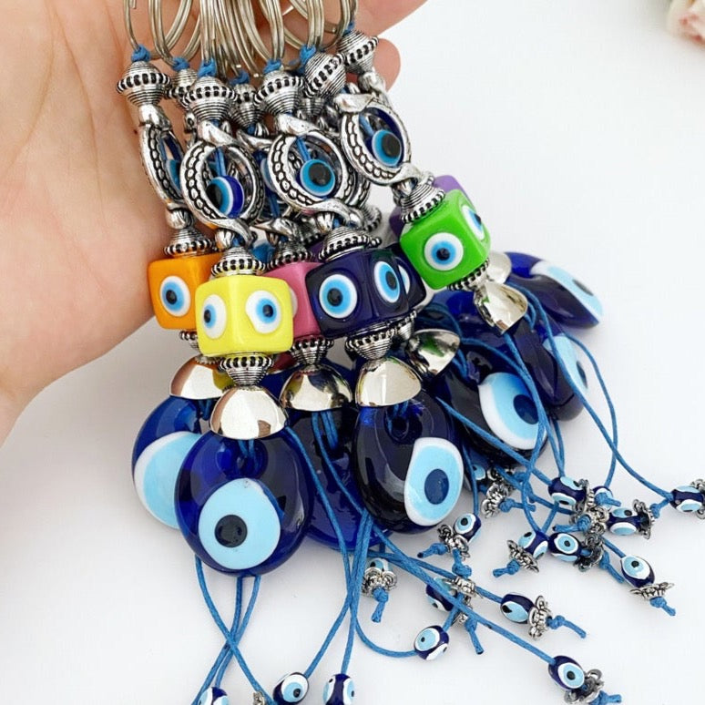 Colorful evil eye key chain with rainbow cube charms, featuring a protective evil eye symbol and vibrant colors.