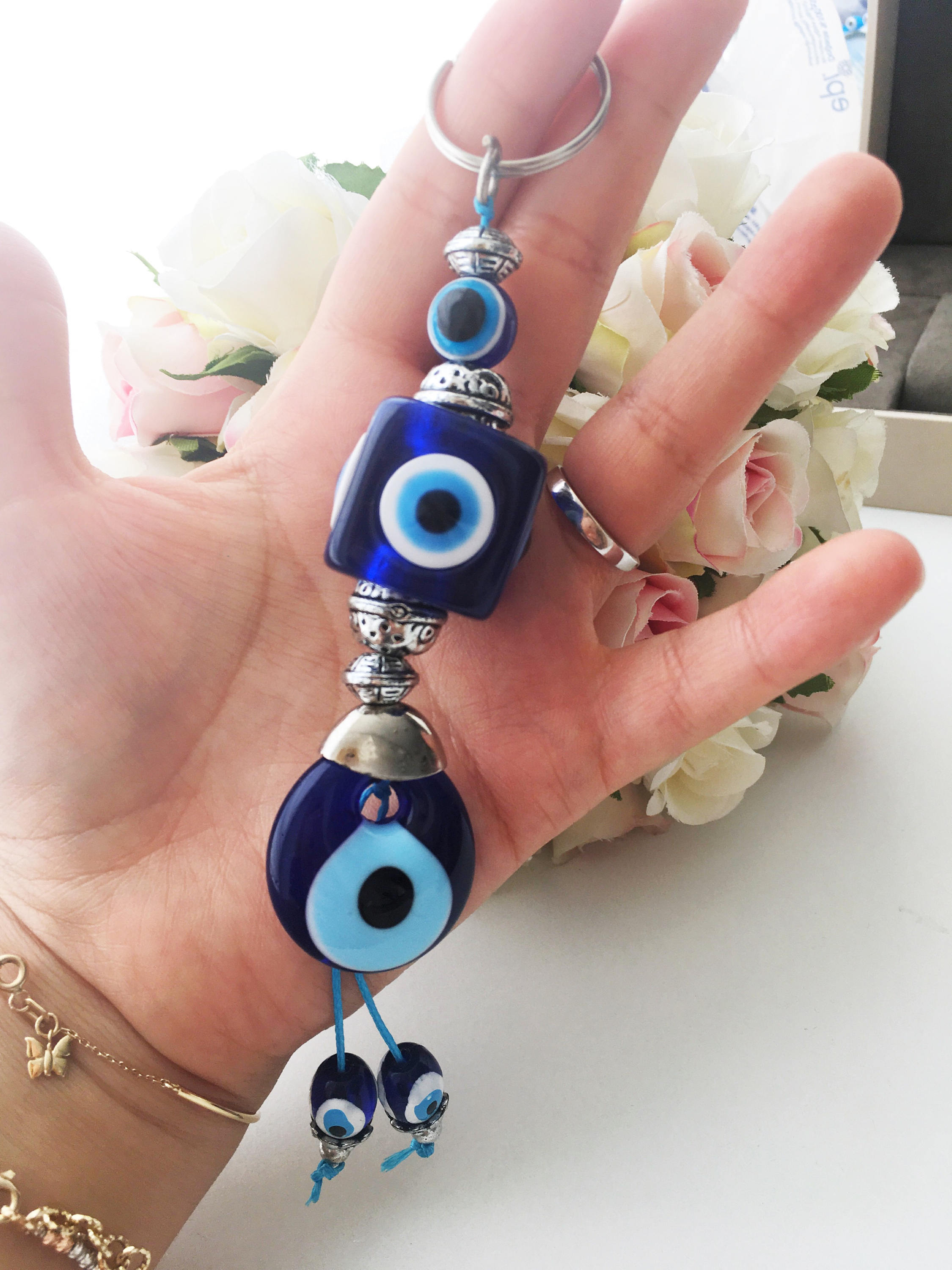A beautiful evil eye key chain featuring square evil eye beads, symbolizing protection and good luck.