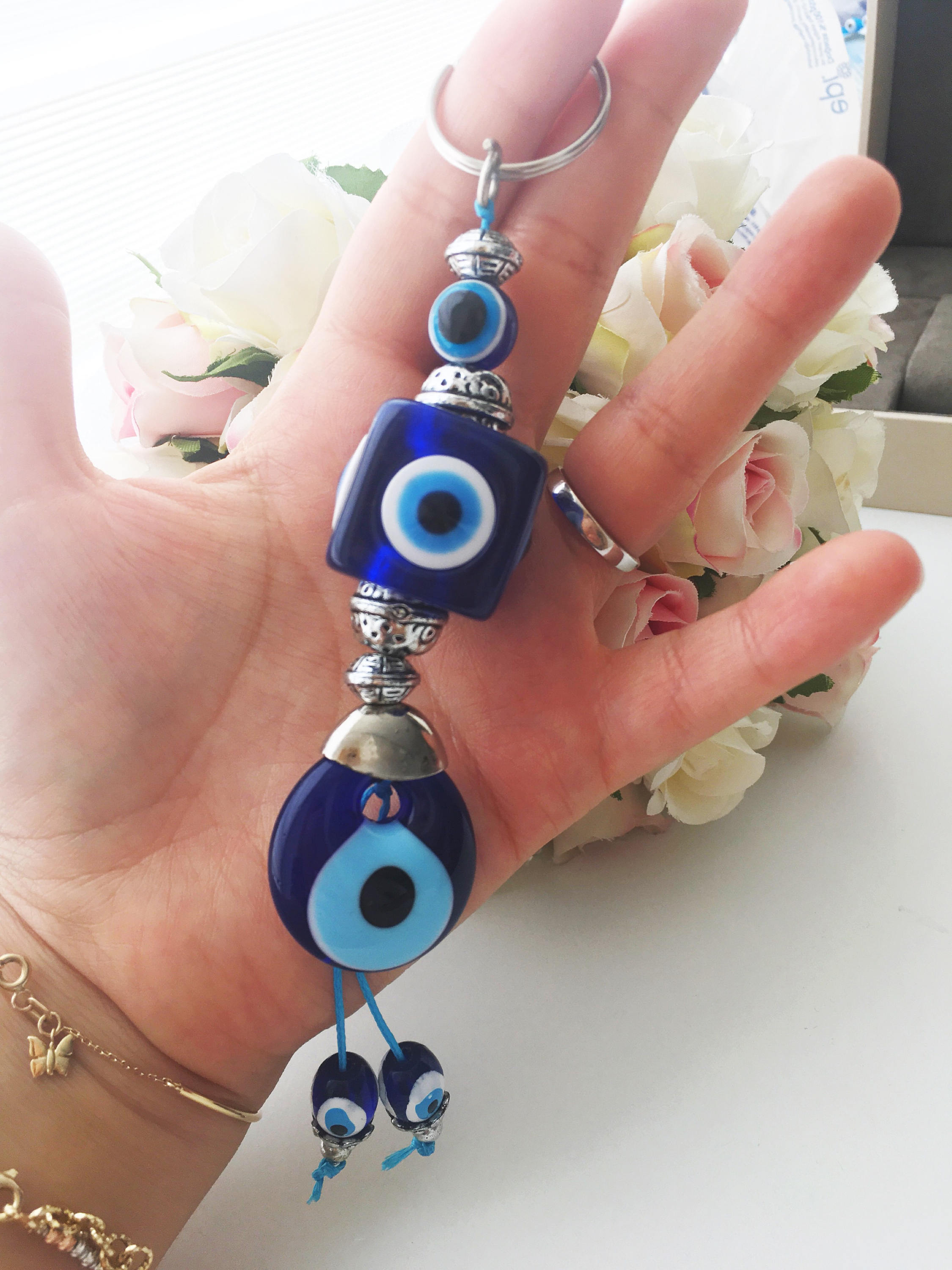 A beautiful evil eye key chain featuring square evil eye beads, symbolizing protection and good luck.