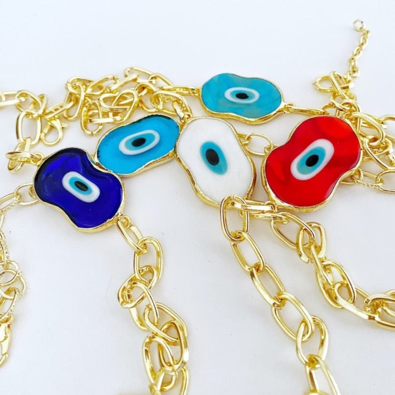 Evil Eye Murano Bracelet featuring handmade glass beads and a gold chain, showcasing a blue evil eye charm.