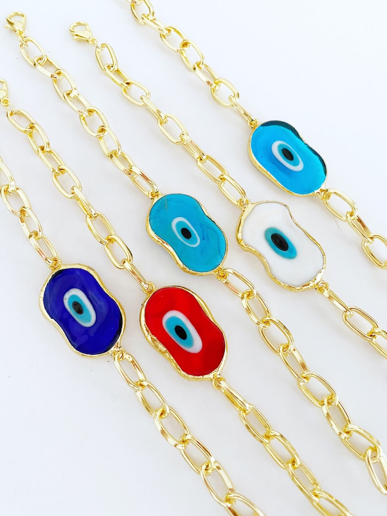 Evil Eye Murano Bracelet featuring handmade glass beads and a gold chain, showcasing a blue evil eye charm.