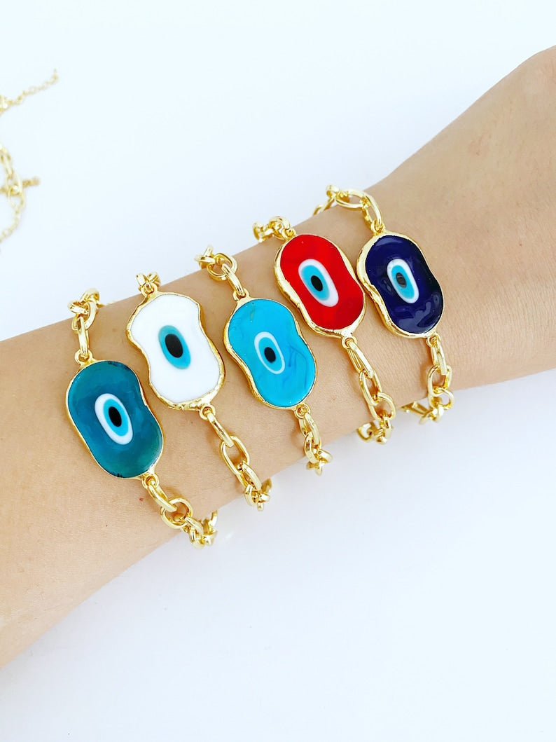 Evil Eye Murano Bracelet featuring handmade glass beads and a gold chain, showcasing a blue evil eye charm.