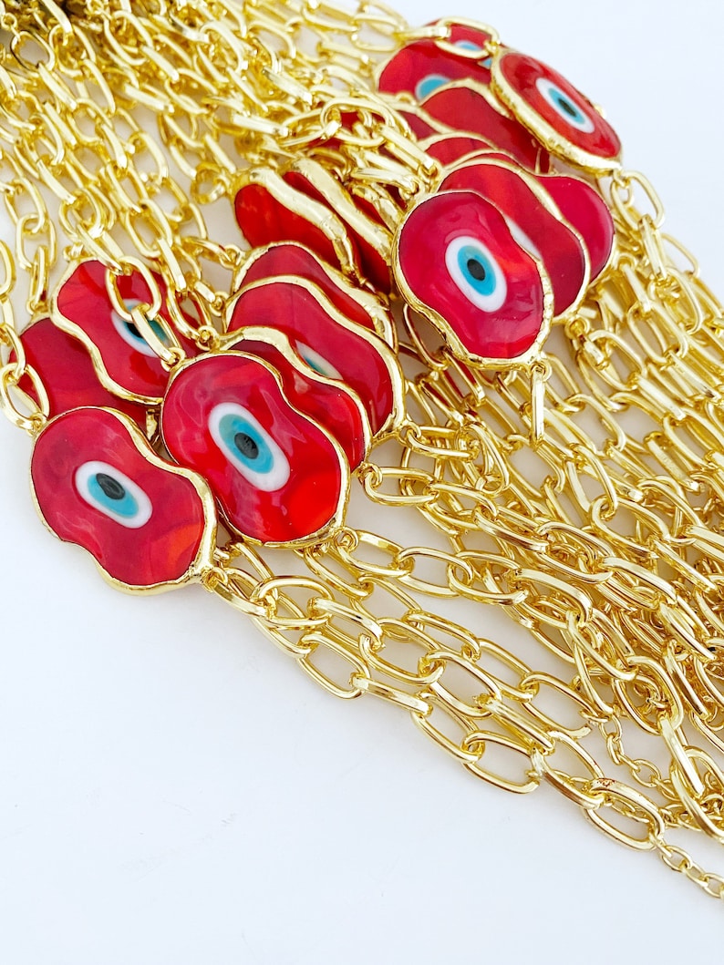 Evil Eye Murano Bracelet featuring handmade glass beads and a gold chain, showcasing a blue evil eye charm.