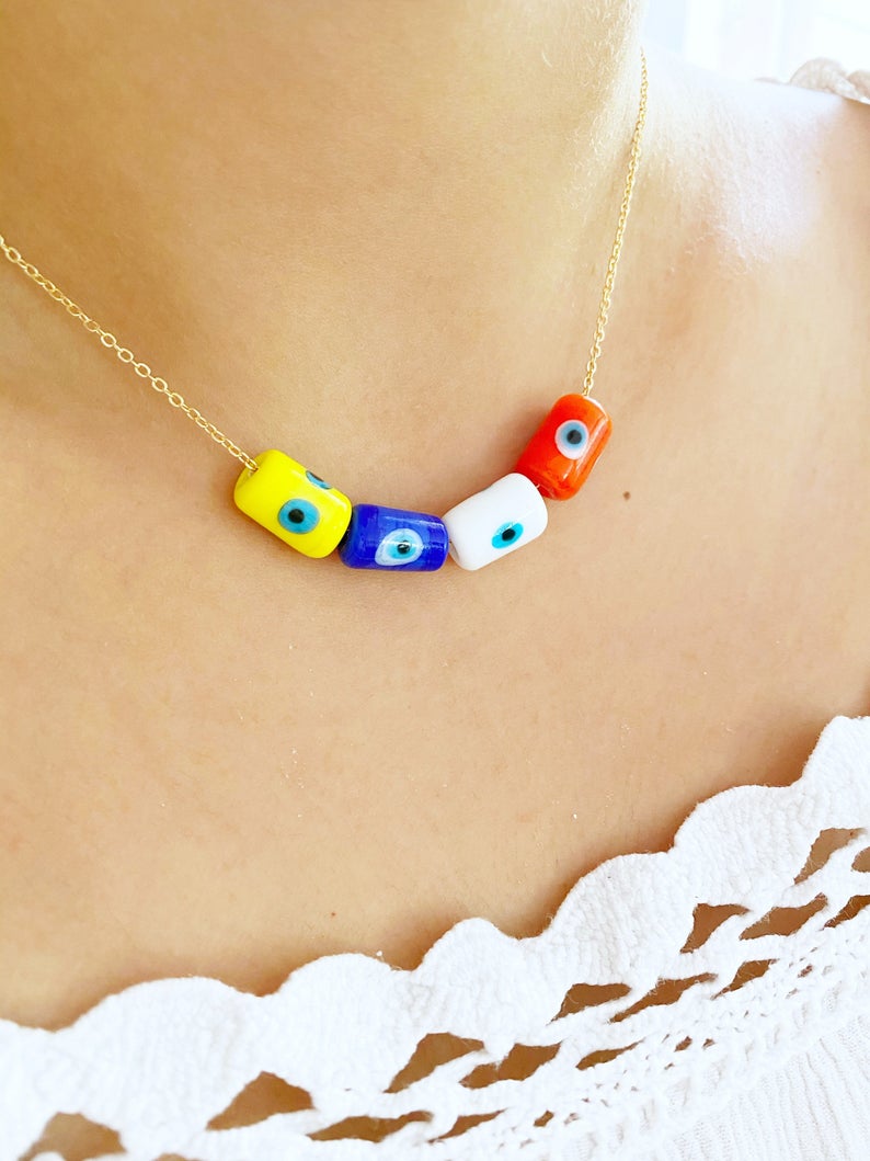 A beautifully handcrafted Evil Eye Necklace featuring colorful Murano tube beads and a stainless steel chain in gold or silver.