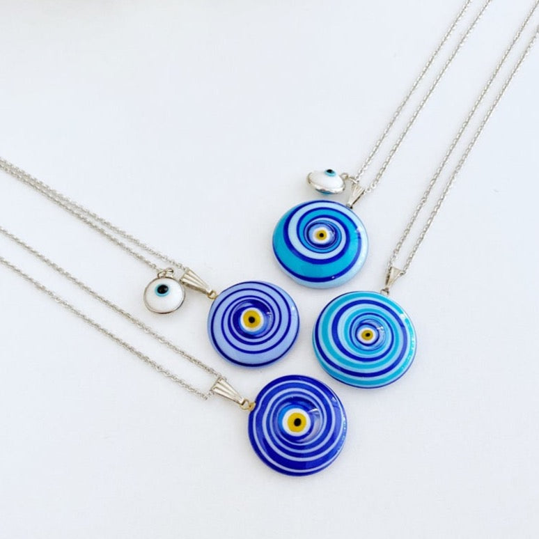 Elegant Evil Eye Necklace featuring a large Murano glass bead in blue or turquoise, complemented by a silver chain and optional white evil eye bead.