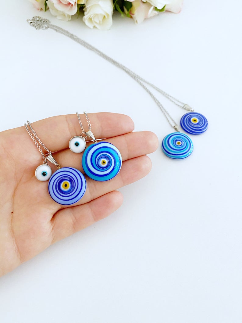 Elegant Evil Eye Necklace featuring a large Murano glass bead in blue or turquoise, complemented by a silver chain and optional white evil eye bead.
