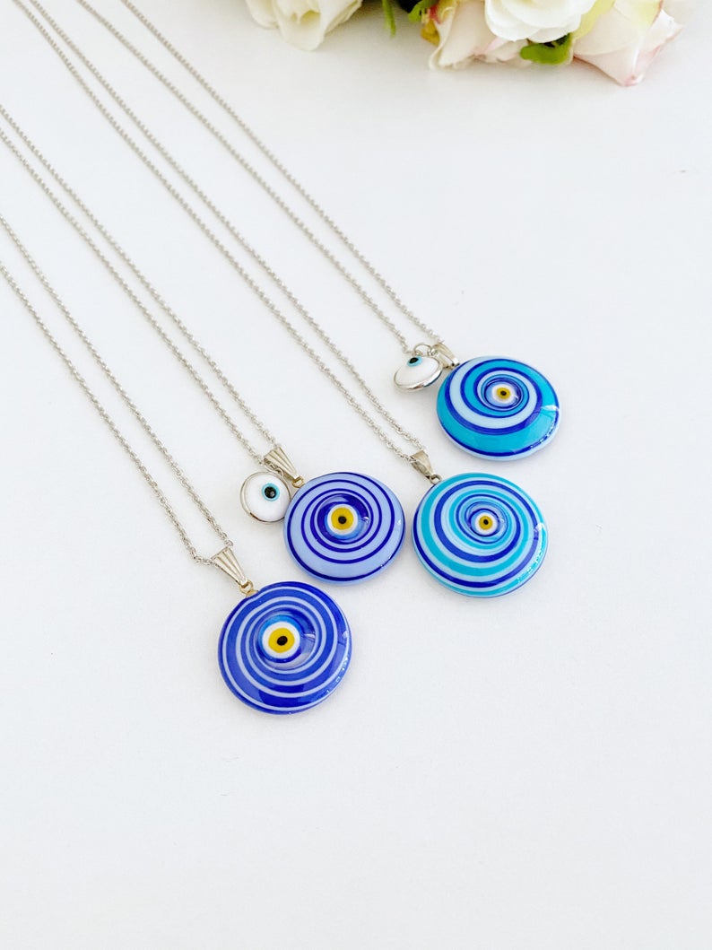 Elegant Evil Eye Necklace featuring a large Murano glass bead in blue or turquoise, complemented by a silver chain and optional white evil eye bead.