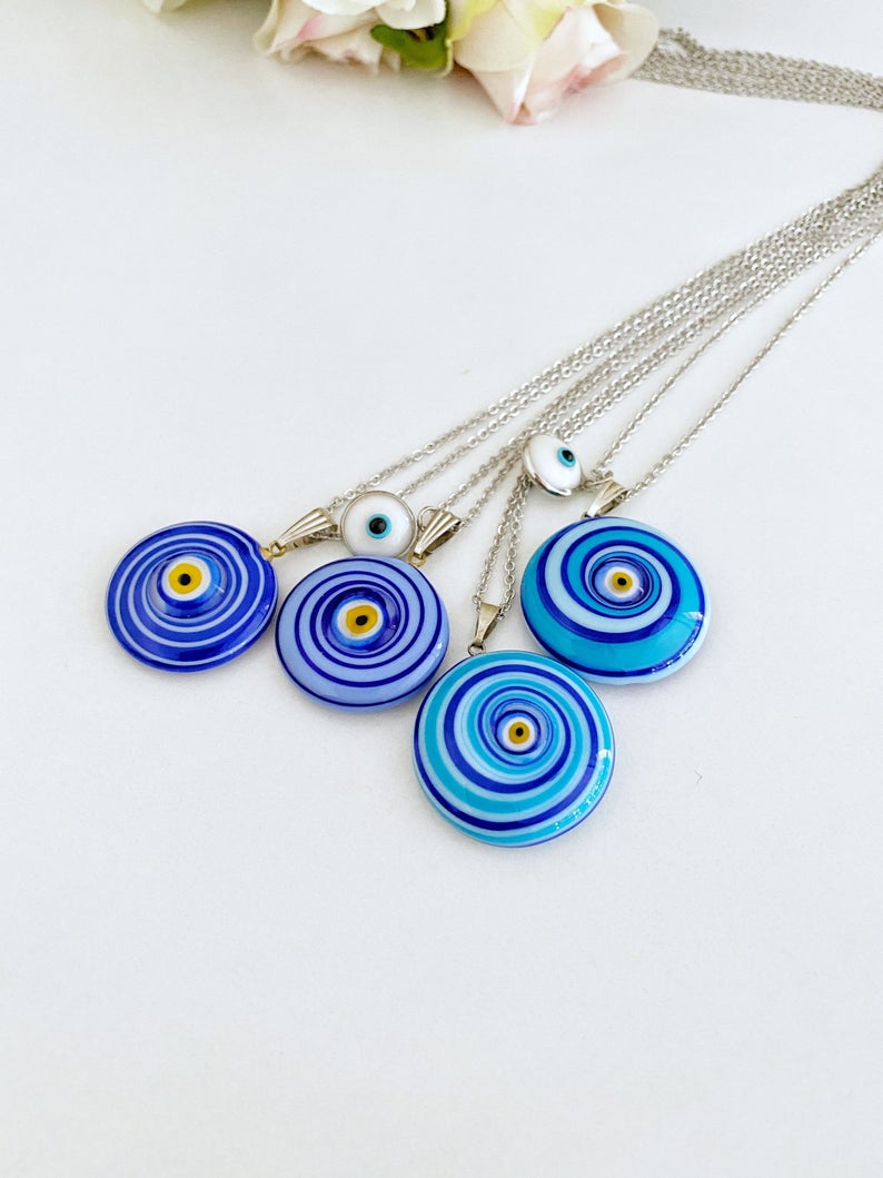 Elegant Evil Eye Necklace featuring a large Murano glass bead in blue or turquoise, complemented by a silver chain and optional white evil eye bead.