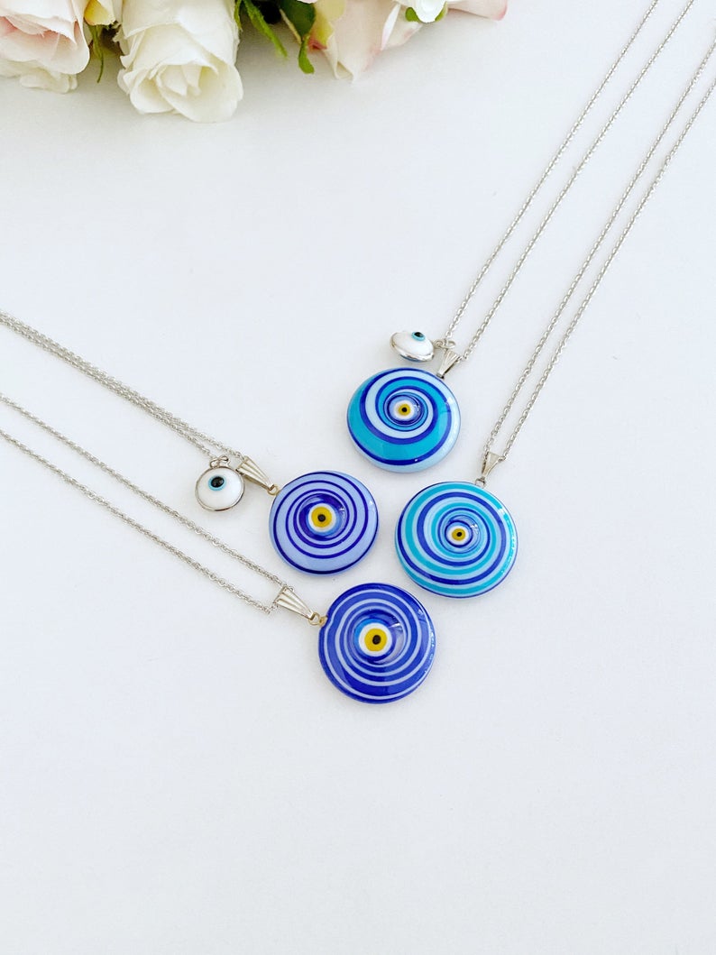 Elegant Evil Eye Necklace featuring a large Murano glass bead in blue or turquoise, complemented by a silver chain and optional white evil eye bead.