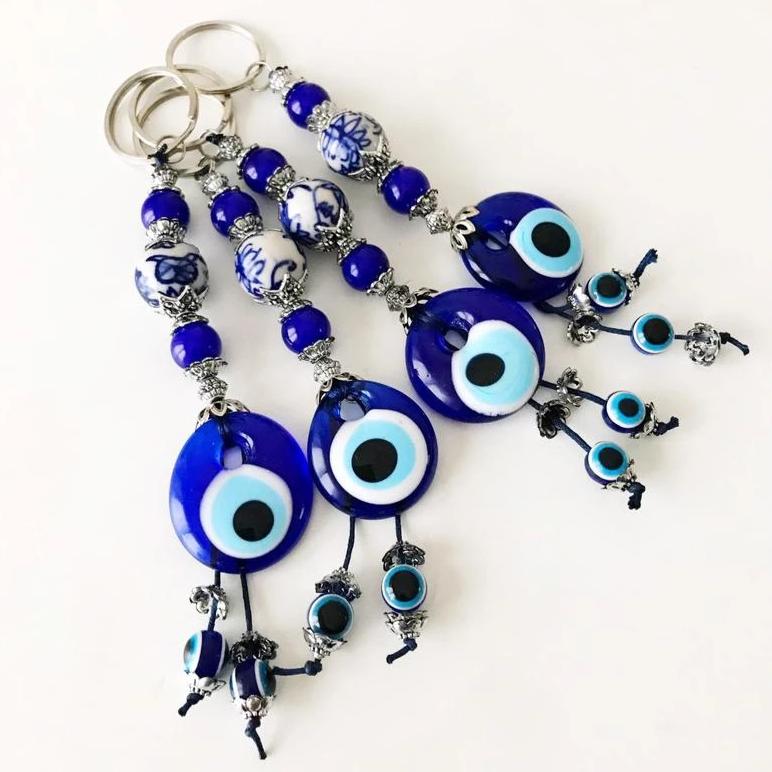 Evil eye protection keychain featuring a ceramic charm, vibrant colors, and intricate design, perfect for keys or bags.