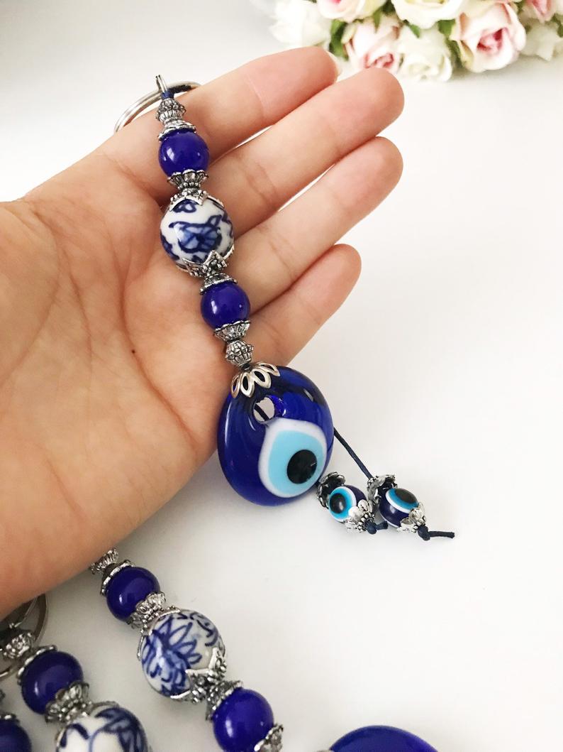 Evil eye protection keychain featuring a ceramic charm, vibrant colors, and intricate design, perfect for keys or bags.