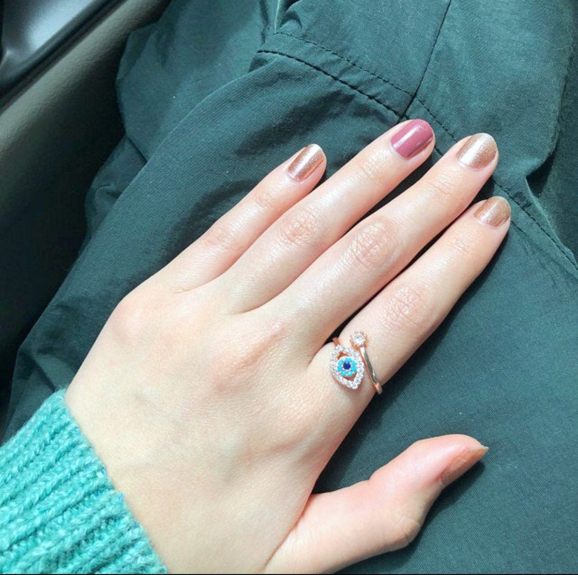 Evil Eye Ring featuring a blue eye design, available in gold, silver, and rose gold, adorned with zircon charms.