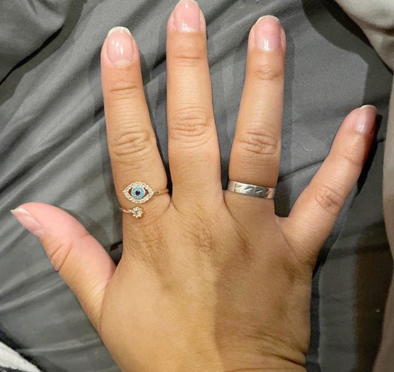 Evil Eye Ring featuring a blue eye design, available in gold, silver, and rose gold, adorned with zircon charms.