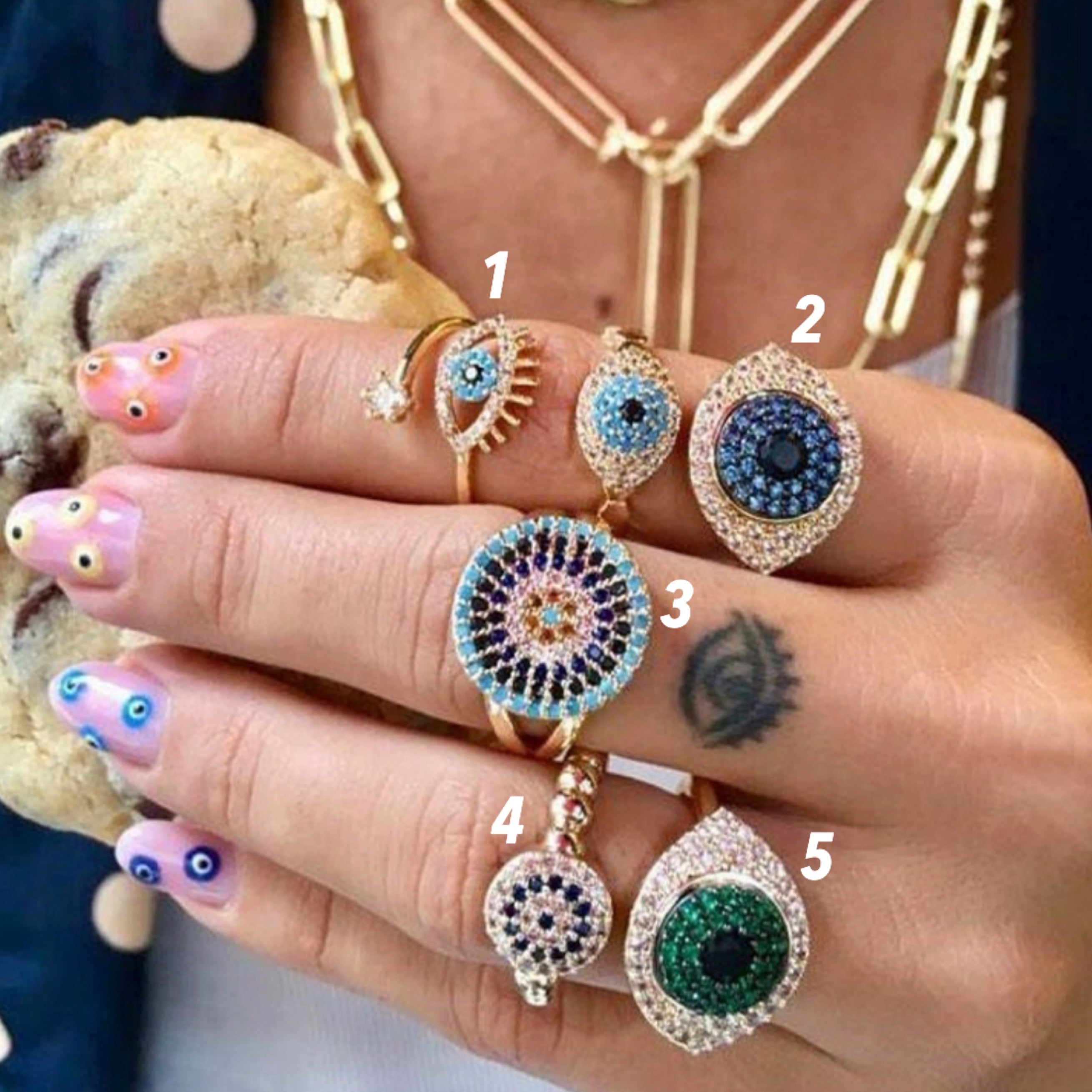 Adjustable Evil Eye Ring Set featuring zircon charms in rose gold, gold, and silver, showcasing a minimalist design.