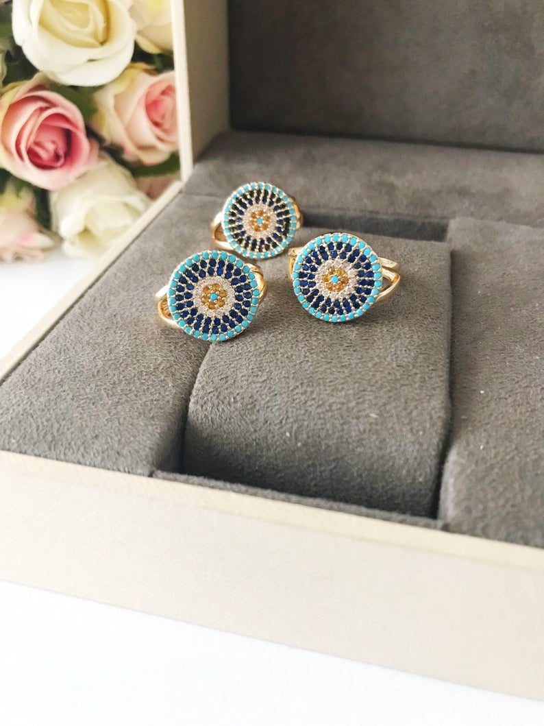 Adjustable Evil Eye Ring Set featuring zircon charms in rose gold, gold, and silver, showcasing a minimalist design.