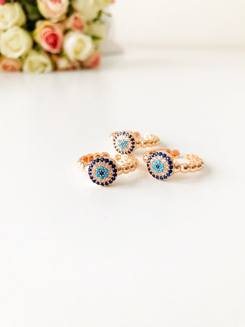 Adjustable Evil Eye Ring Set featuring zircon charms in rose gold, gold, and silver, showcasing a minimalist design.