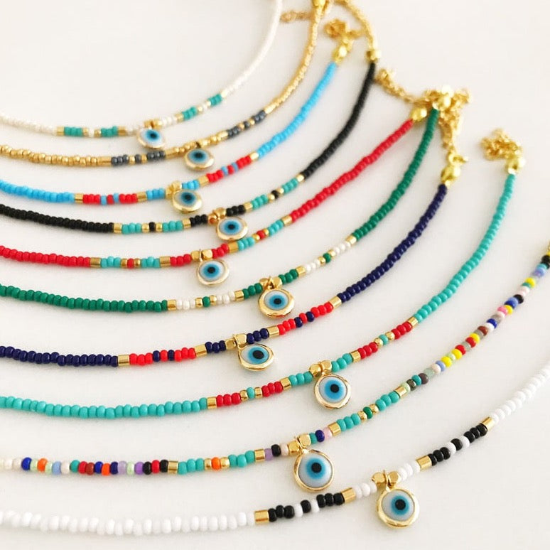 Handmade Evil Eye Seed Beads Bracelet featuring a white evil eye bead, adjustable size, and vibrant Miyuki seed beads.