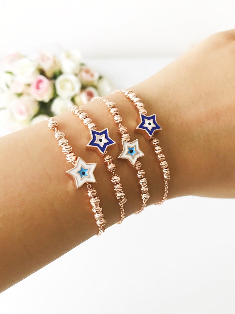 Evil Eye Star Bracelet featuring a rose gold bead chain with blue evil eye and star charm, handmade and adjustable.