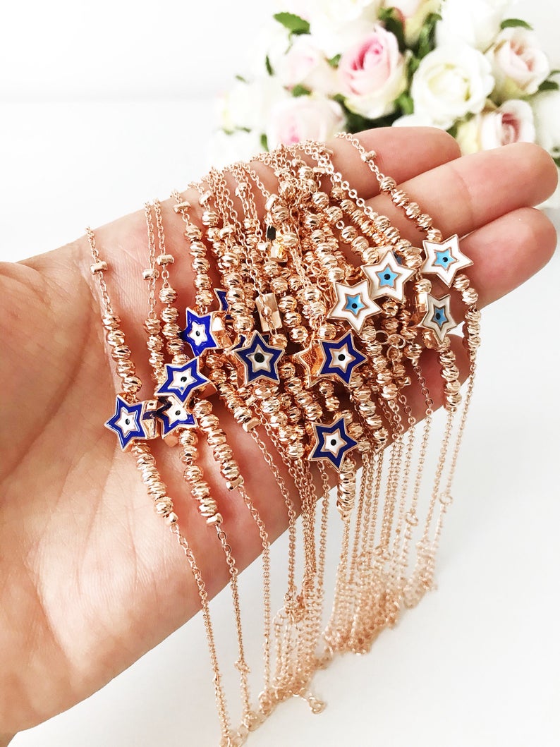 Evil Eye Star Bracelet featuring a rose gold bead chain with blue evil eye and star charm, handmade and adjustable.