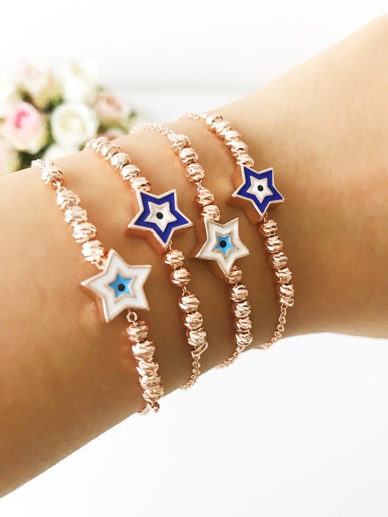 Evil Eye Star Bracelet featuring a rose gold bead chain with blue evil eye and star charm, handmade and adjustable.