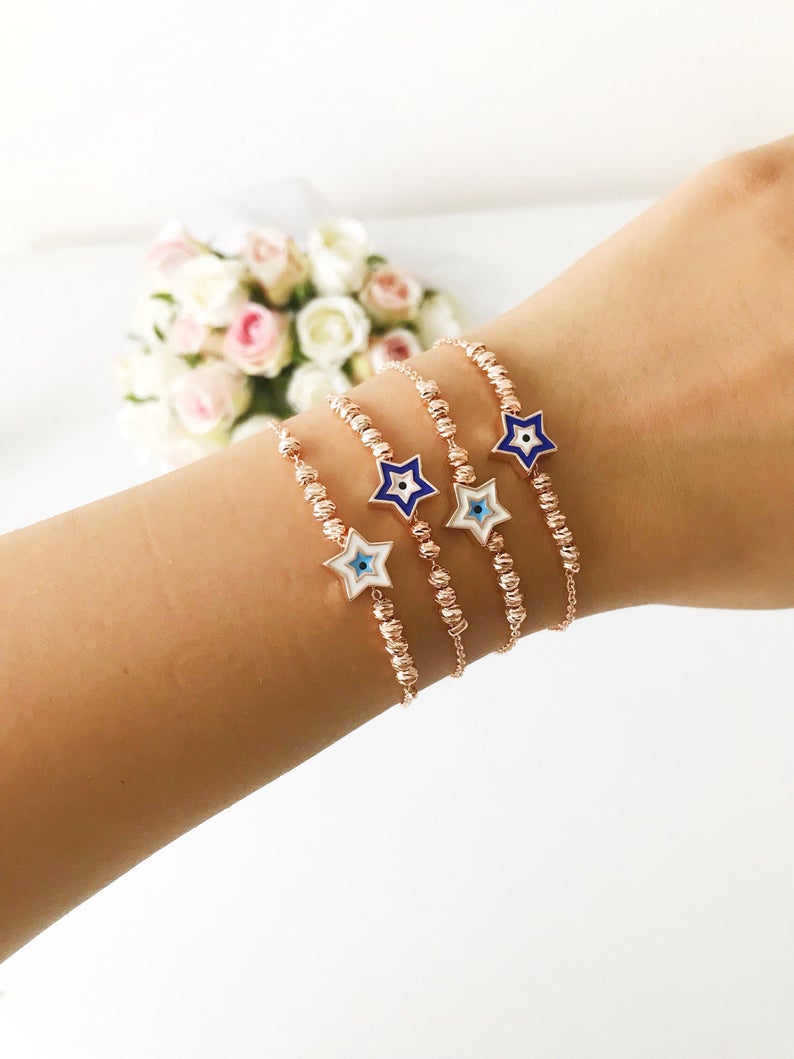 Evil Eye Star Bracelet featuring a rose gold bead chain with blue evil eye and star charm, handmade and adjustable.