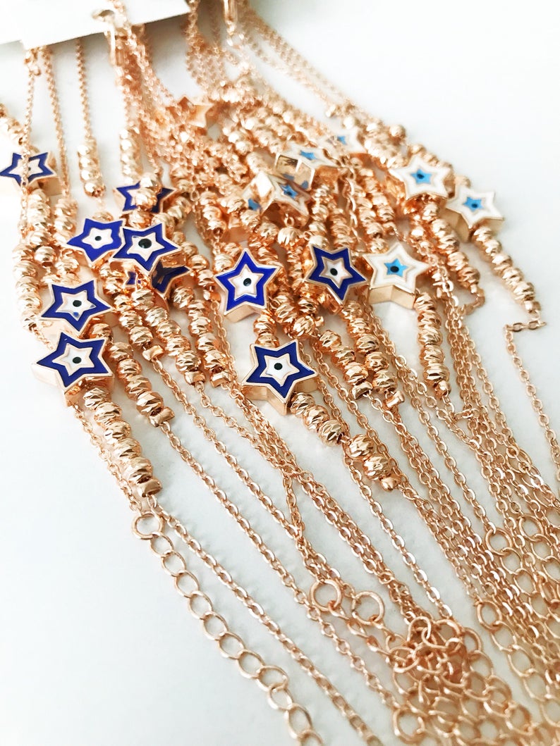 Evil Eye Star Bracelet featuring a rose gold bead chain with blue evil eye and star charm, handmade and adjustable.