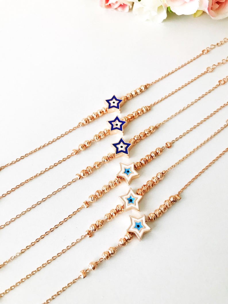Evil Eye Star Bracelet featuring a rose gold bead chain with blue evil eye and star charm, handmade and adjustable.