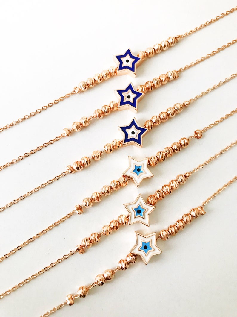 Evil Eye Star Bracelet featuring a rose gold bead chain with blue evil eye and star charm, handmade and adjustable.